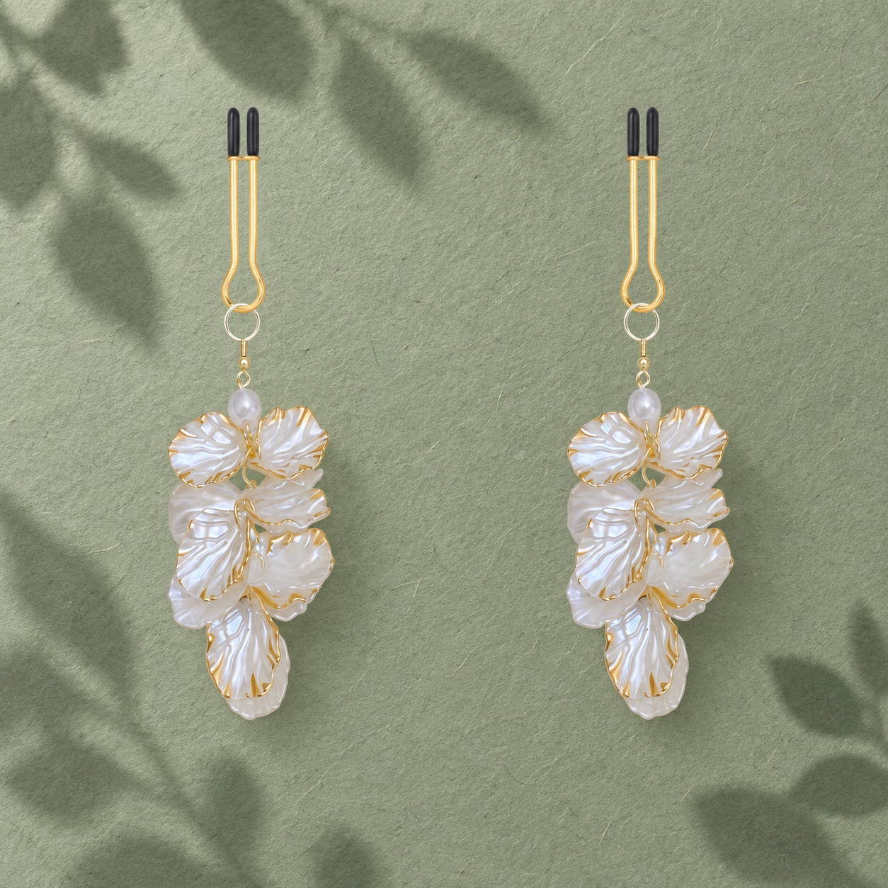 Petal Cascade body adornments with iridescent petals and gold-tone edges in a botanical setting